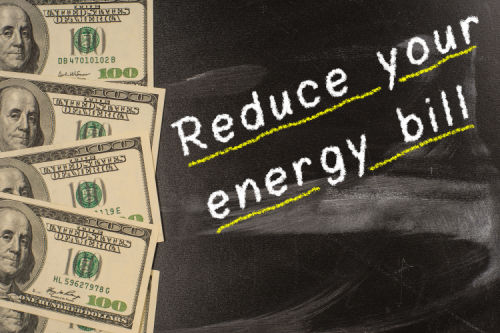 Text on blackboard with money - Reduce your energy bill